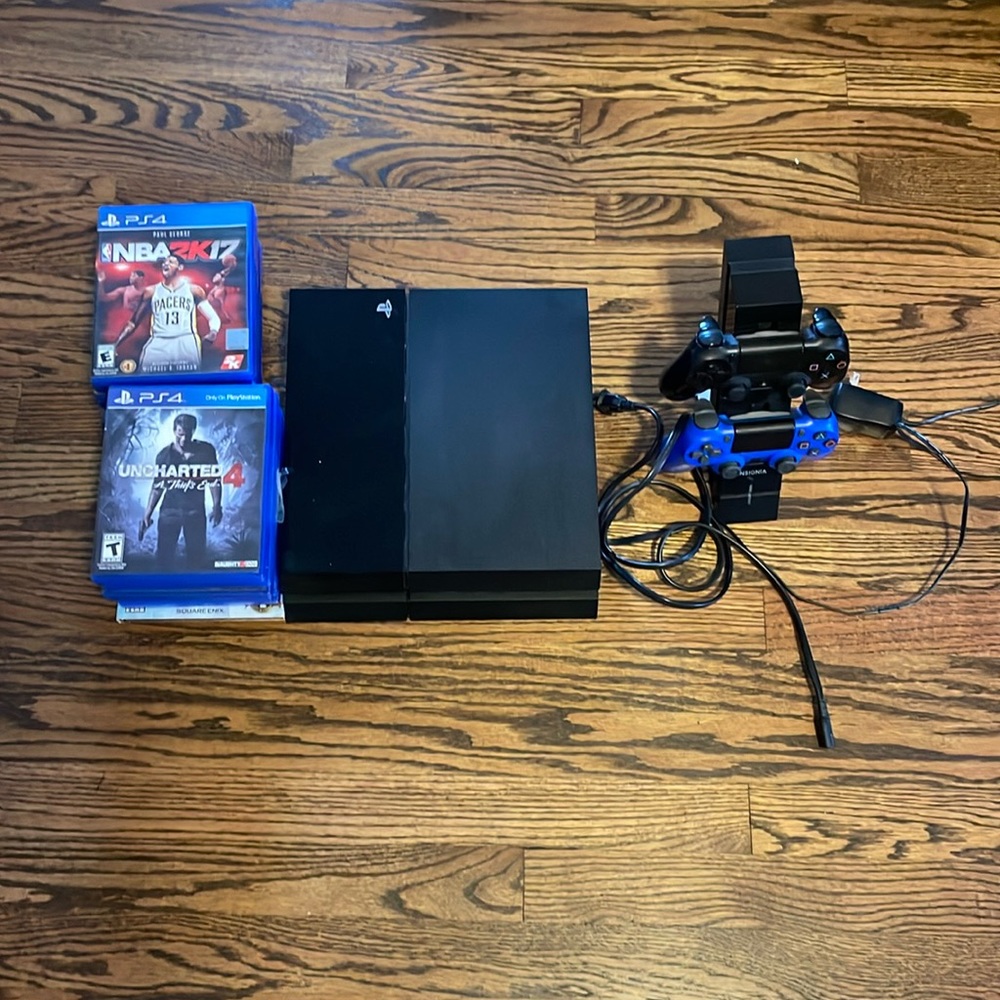 PS4 Console with dual controllers, controller charging station with 16 PS4 games